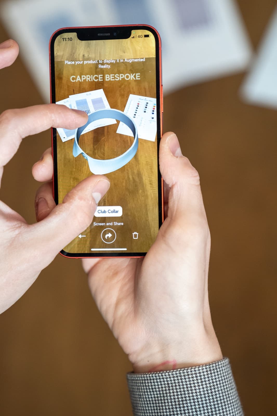 A tailored collar shown in augmented reality above the atelier table.